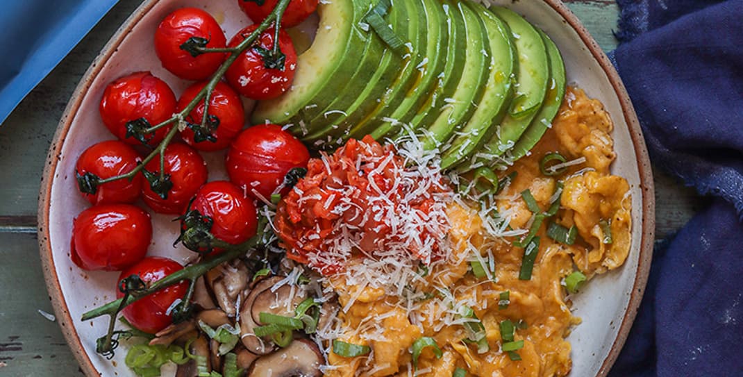Scrambled eggs with roasted tomatoes, mushrooms, avocado and kimchi