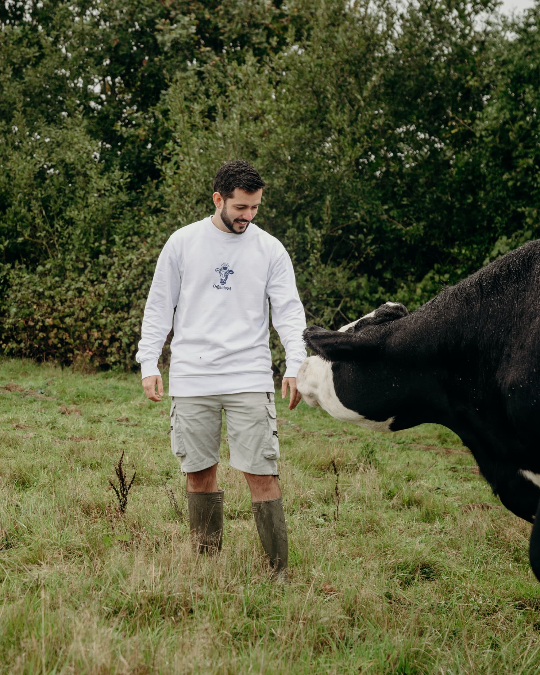 A man walking through a green field