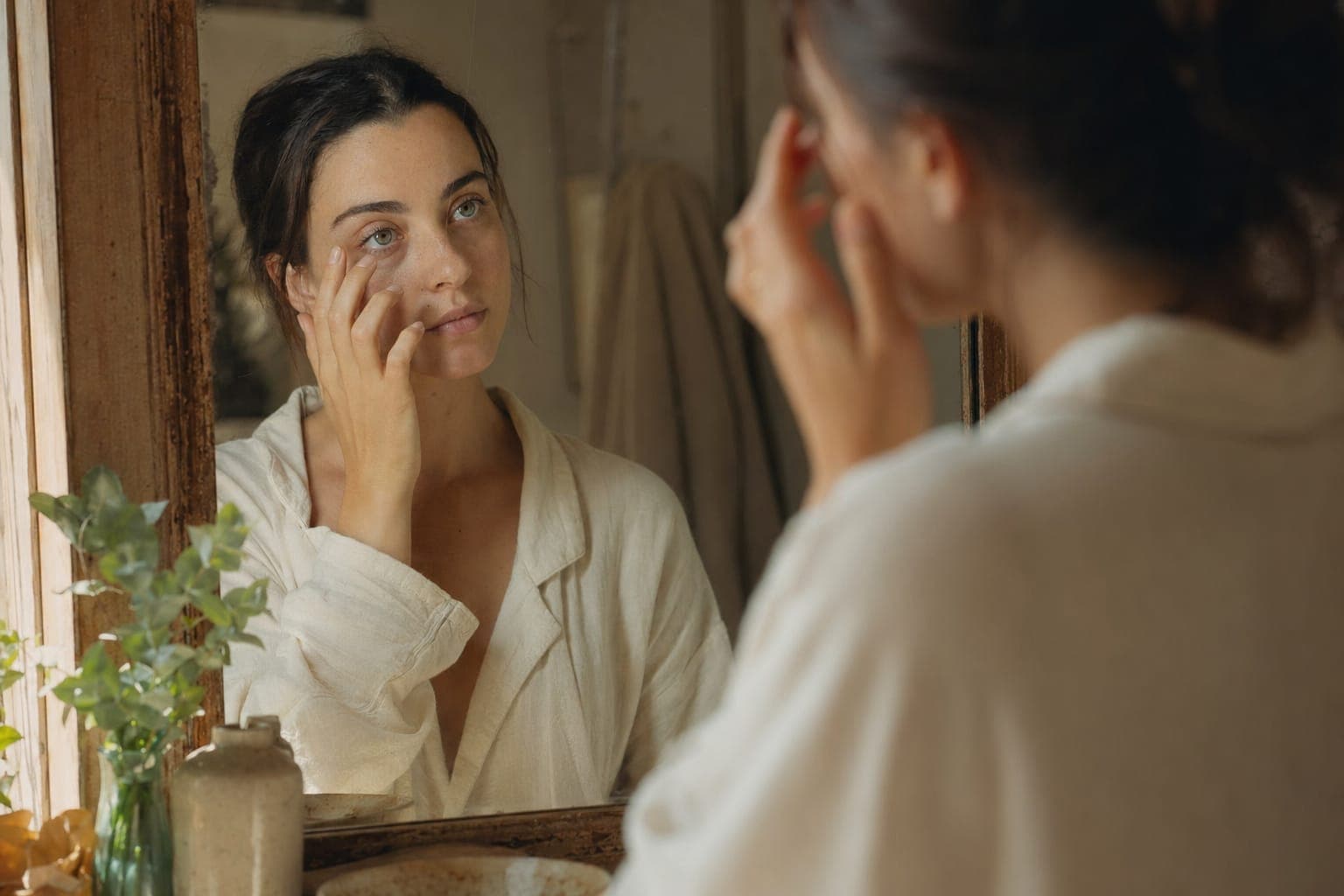 A person resting with eyes closed in soft natural light