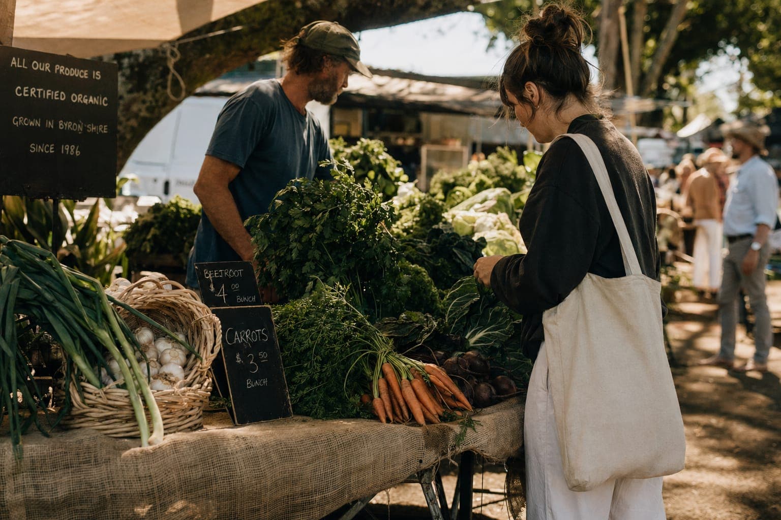 A person holding a basket of fresh vegetables in a garden in warm light