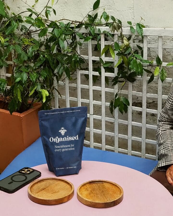 The Organised pouch on a garden table, a hot chocolate being made