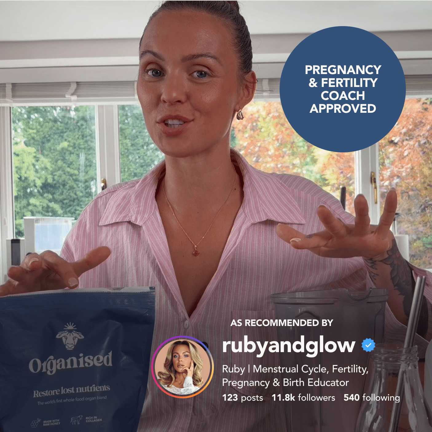 Ruby + Glow holding the Organised pouch in her kitchen, under a pregnancy and fertility coach approved badge and her Instagram recommendation as rubyandglow