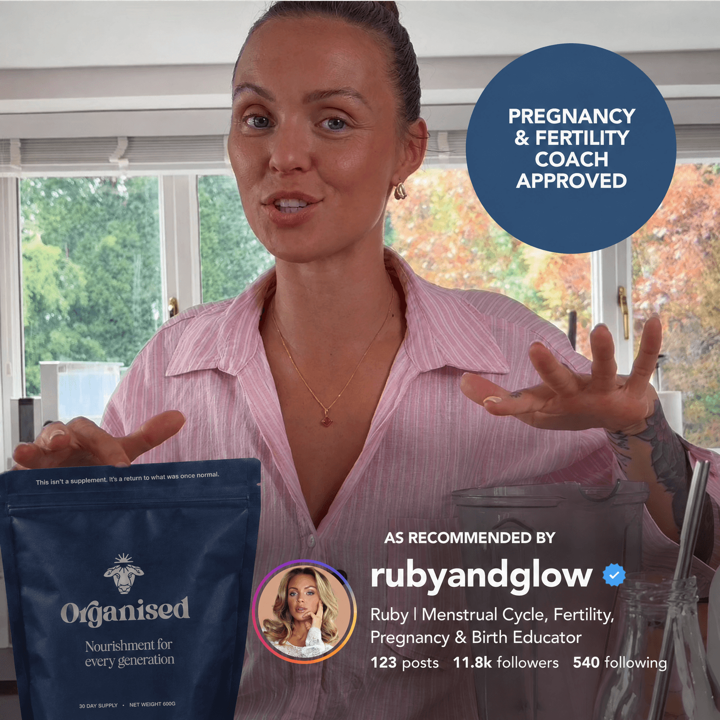 Ruby + Glow holding the Organised pouch in her kitchen, under a pregnancy and fertility coach approved badge and her Instagram recommendation as rubyandglow