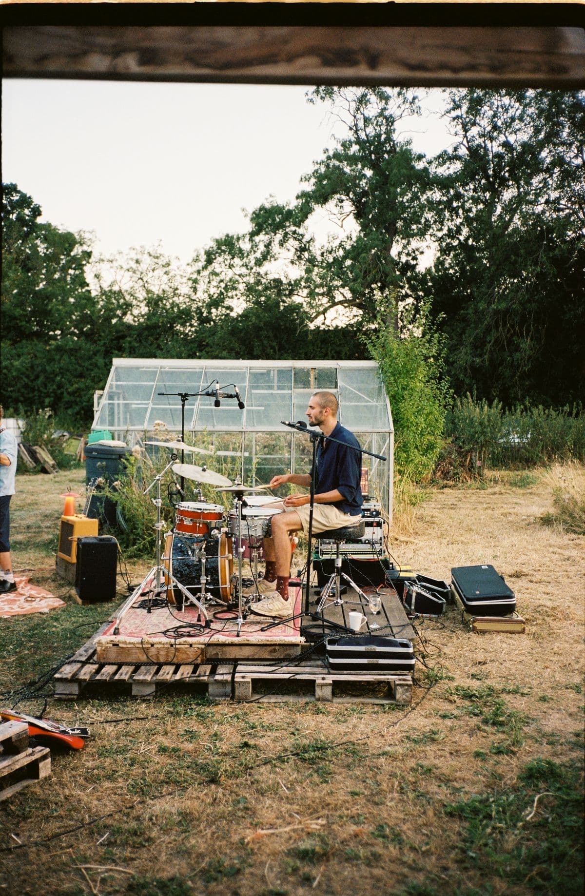 The band set up by the greenhouse as the light fades