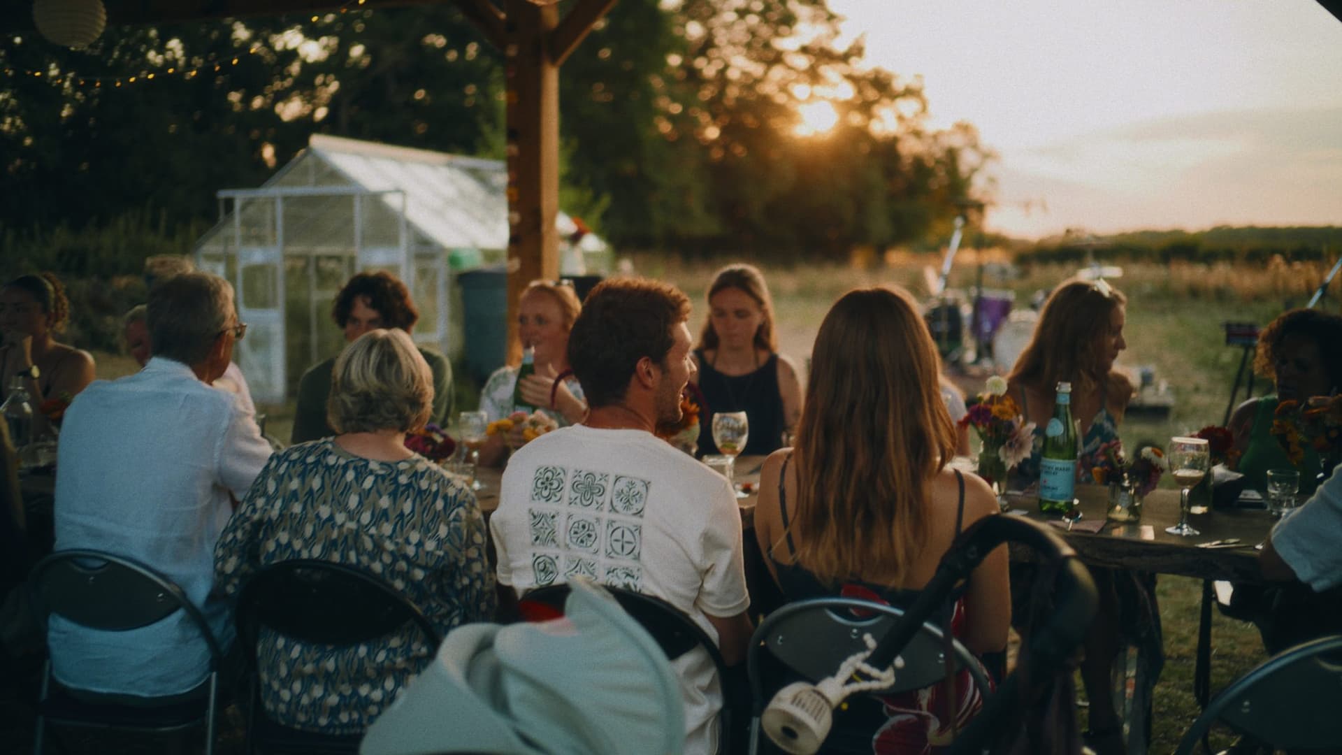 The supper club table at sunset, the sun dropping behind the guests