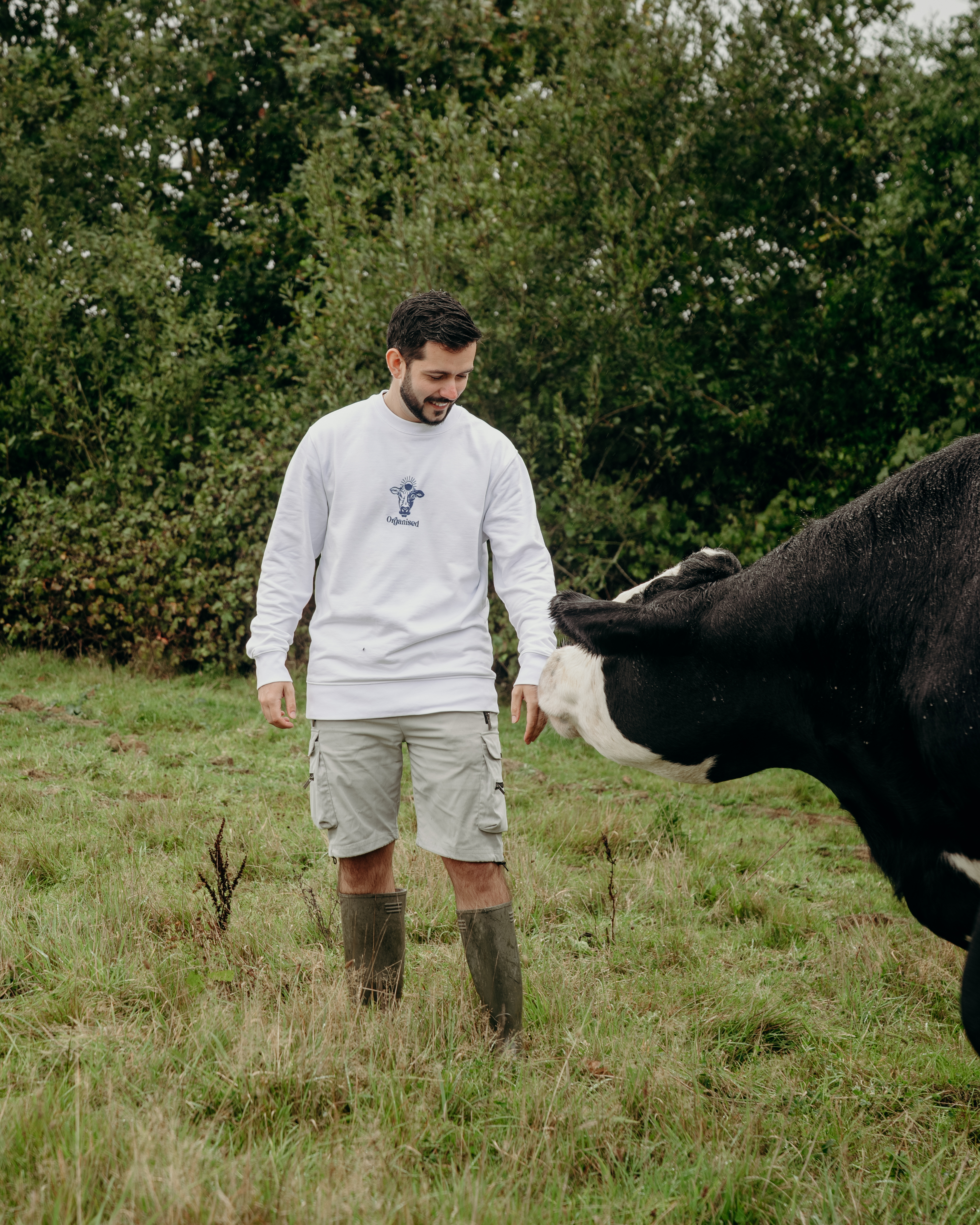 Man walking through a green field in nature