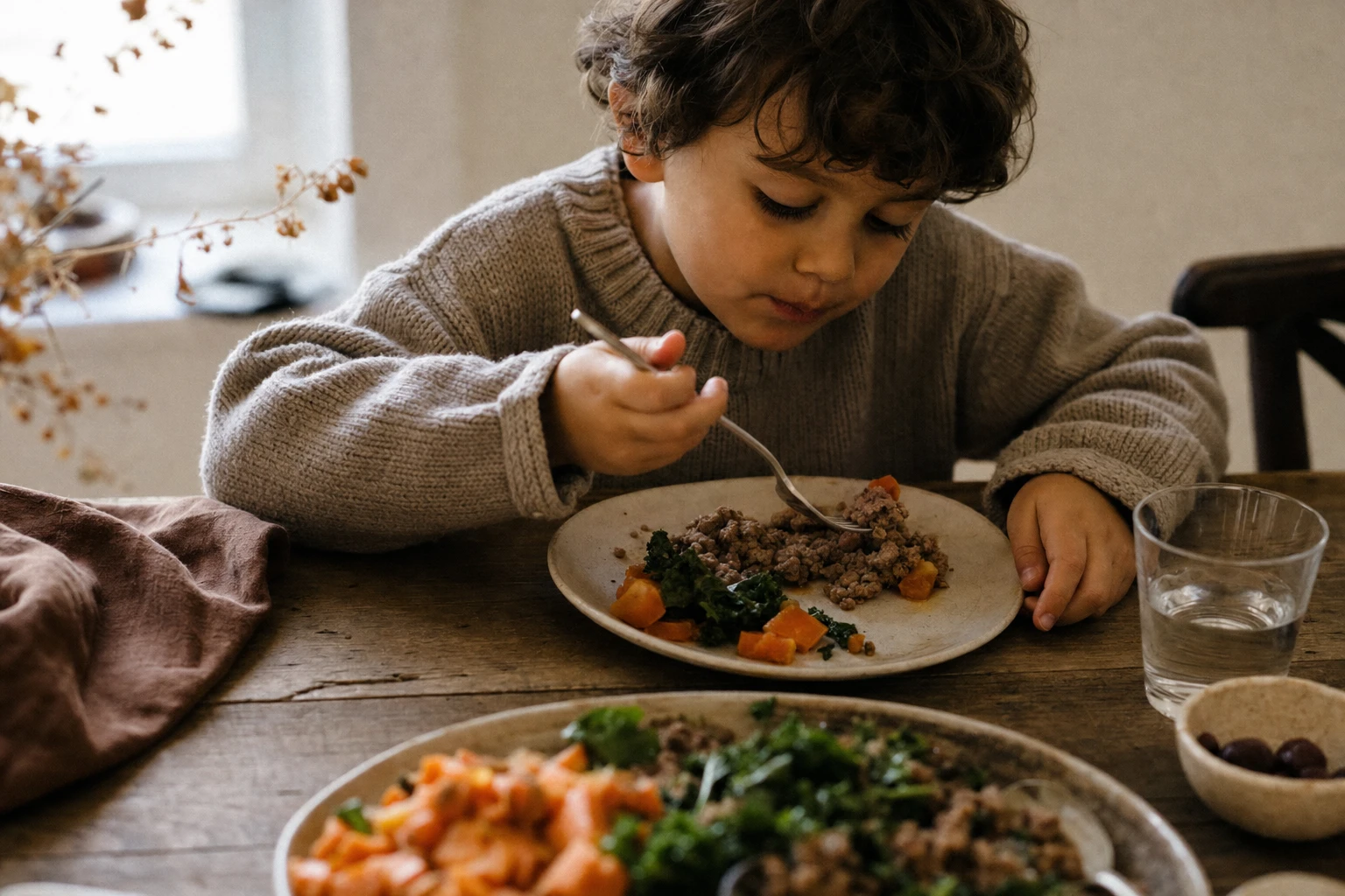 Child eating mixed meat dish