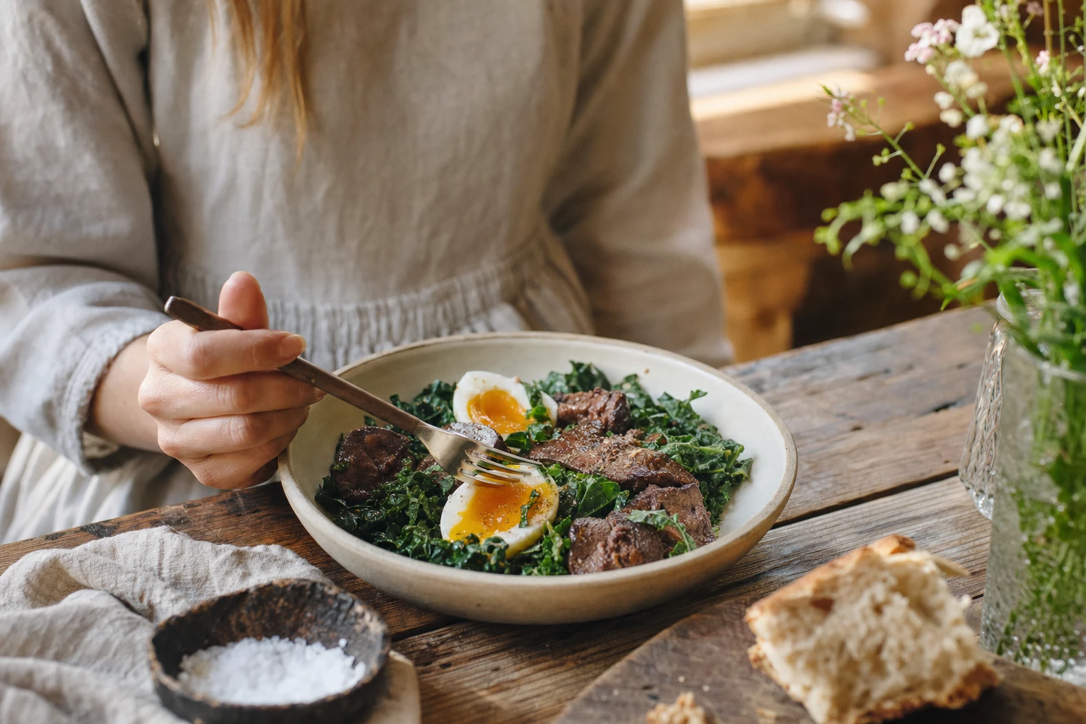 Bowl of leafy greens with liver and eggs