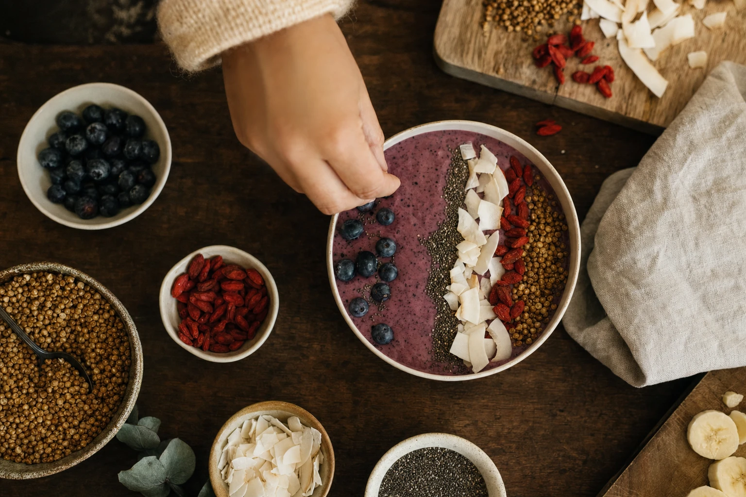 Toppings being added to a smoothie bowl in sections